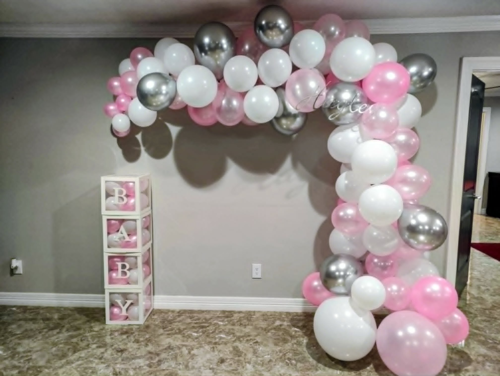 Pastel balloon garland and backdrop styled for a baby shower in Cypress, Texas