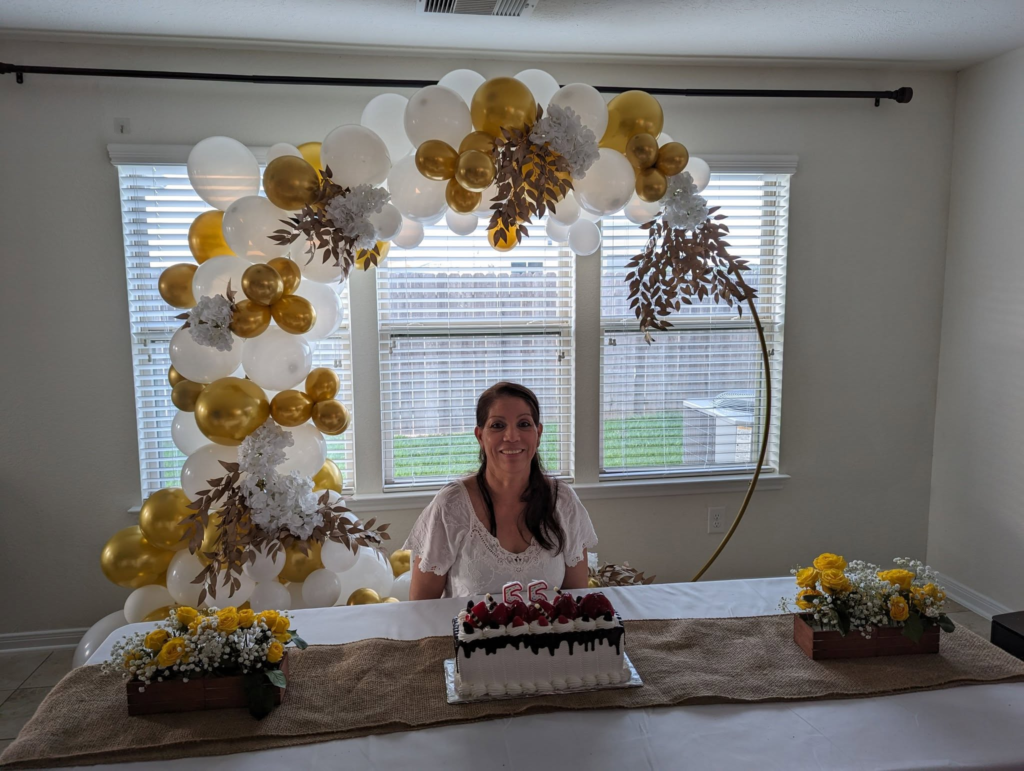 Elegant gold and white balloon installation styled for a milestone birthday in a Houston home