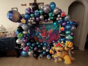 Chrome purple, blue, and silver organic balloon ring with star and planet foils around a party backdrop.